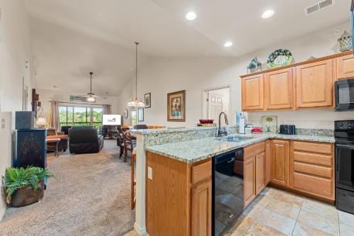 a kitchen with wooden cabinets and a counter top at Ozark Comfort Condo in Branson West