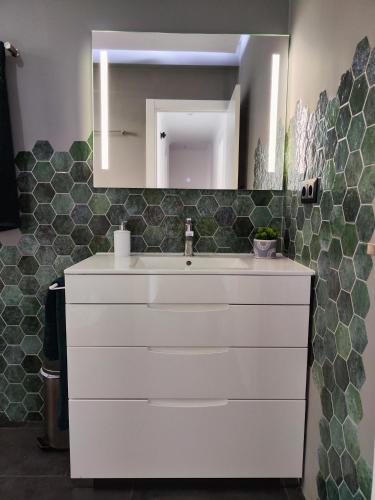 a bathroom with a white sink and a mirror at Experiencia Premium en la Esencia de Denia in Denia