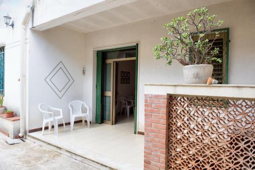 a patio with chairs and a plant in a pot at One bedroom apartement with enclosed garden at Vita in Vita