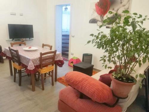 a living room with a table and a plant at 2 bedrooms apartement with sea view furnished terrace and wifi at Pianoconte 2 km away from the beach in Piano Conte