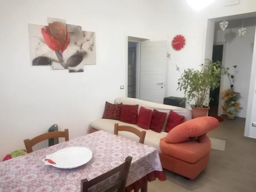 a living room with a table and a couch at 2 bedrooms apartement with sea view furnished terrace and wifi at Pianoconte 2 km away from the beach in Piano Conte
