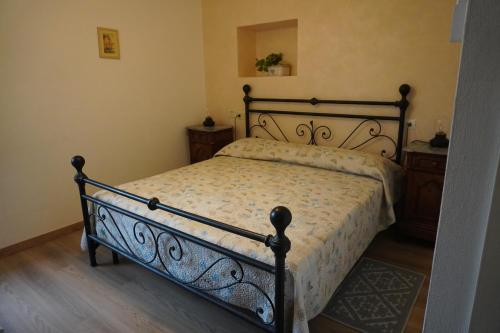 a bedroom with a bed with a wrought iron frame at Albergo Giardinetto in Bellagio