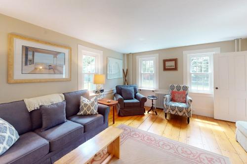a living room with a couch and two chairs at Gray Gables in Orleans