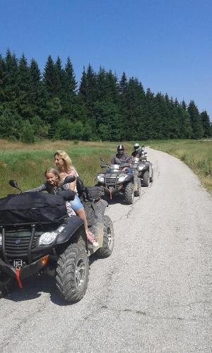 a group of people riding atvs down a dirt road at Gledkata Complex in Skobelevo