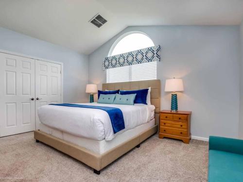 a bedroom with a large bed and a window at Pixie Hollow in Kissimmee