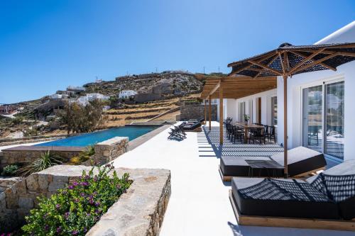 a house with a patio and a swimming pool at Elit Villa Psarou in Psarou