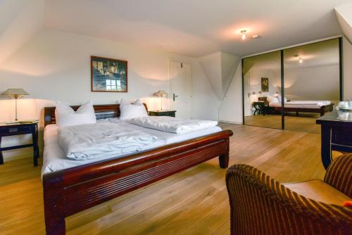 a bedroom with a bed and a living room at Litzkow 16101 in Archsum