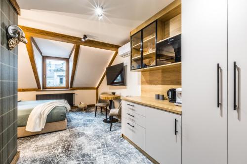 a small bedroom with a bed and a desk at Apartamenty ForRest Krupówki in Zakopane