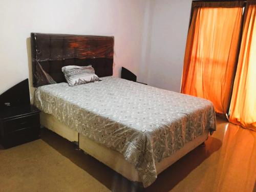 a bedroom with a bed with a pillow on it at LA CASA DE ABI Y EMILIIO in Tarapoto