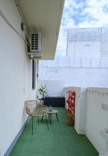 a small balcony with a chair and a table at Sarah's Penthouse in Sliema in Sliema