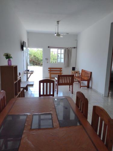 a dining room and living room with a table and chairs at Hotel Azulejos in Chachalacas