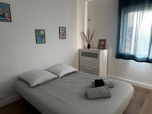 une chambre avec un lit avec deux oreillers dessus dans l'établissement Esprit méditerranéen, à Toulon