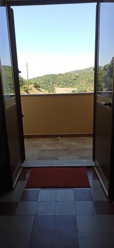 an open door to a room with a view at Borgo Ingurtosu in Ingurtosu