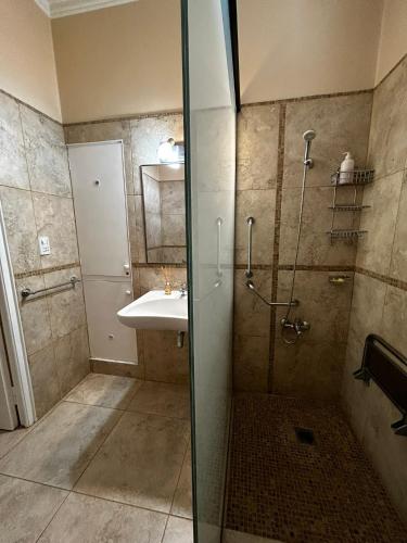a bathroom with a shower and a sink at JURAMA in Ciudad Lujan de Cuyo