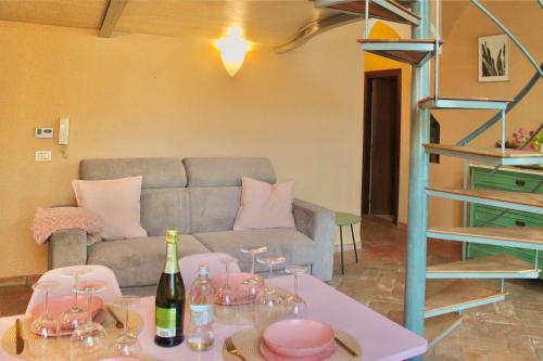 a living room with a couch and a table with wine glasses at The Painter's Nest with Private Lake Garden in Cima