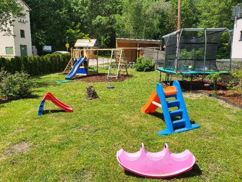 a group of playground equipment in a yard at Kozma Apartments Peterlewand Gerlitzen Ossiachersee in Bodensdorf