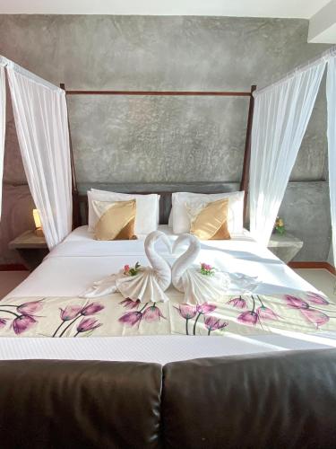 a bed with a heart decoration on it at Lanta Just Come Bungalow in Ko Lanta