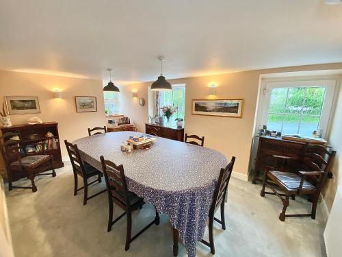 uma sala de jantar com mesa e cadeiras em Lynwood House Bed and Breakfast em Tregoney