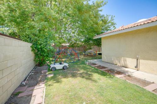 a small car parked in a yard with a playground at Fun-Filled Backyard Bakersfield Family Haven! in Bakersfield