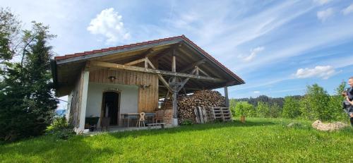 a small building with a roof on a field at Ferienhof Rindalphorn mit Sauna in ländlicher Idylle in Missen-Wilhams