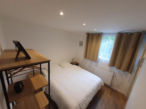 a small bedroom with a bed and a window at Massy Appart Hotel in Massy