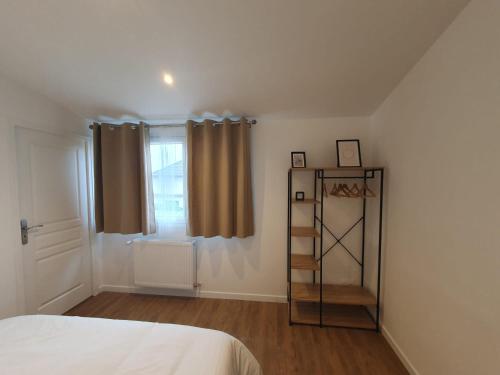 a bedroom with a bed and a book shelf at Massy Appart Hotel in Massy