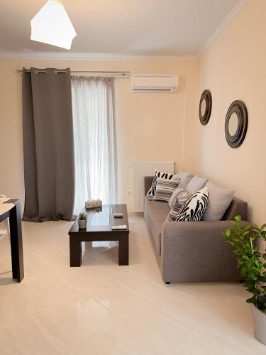 a living room with a couch and a coffee table at Sun n' Salt I Apartment in Tolo