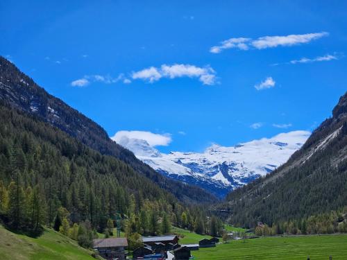a valley in the mountains with snow covered mountains at Apartment Klein Matterhorn - Haus Miranda in Täsch