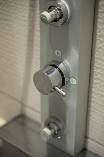 a metal door with two knobs on a bathroom stall at Sea and sun in Kalamitsa