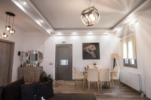a living room with a table and chairs at Sea and sun in Kalamitsa