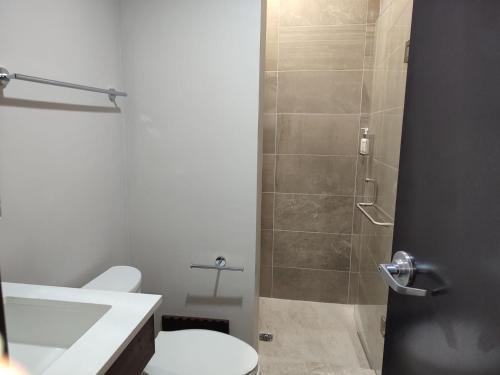 a bathroom with a shower with a toilet and a sink at Holiday Inn Express Morelia Centro Historico in Morelia