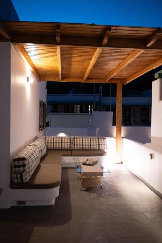 a living room with a couch and a table at Sea and sun in Kalamitsa