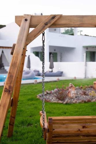 a hand on a swing in a yard at Sea and sun in Kalamitsa