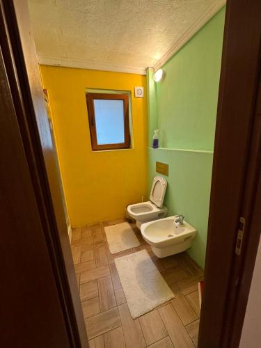 a bathroom with a toilet and a sink at Дом за гости ГЕРГАНА in Pleven