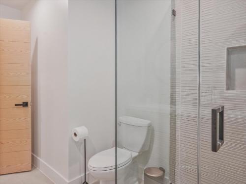 a bathroom with a toilet and a glass shower at Hollywood Dream pool home & king beds in Los Angeles