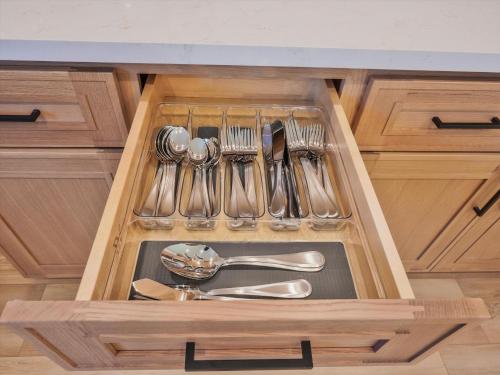 a kitchen sink with utensils in a wooden drawer at Hollywood Dream pool home & king beds in Los Angeles