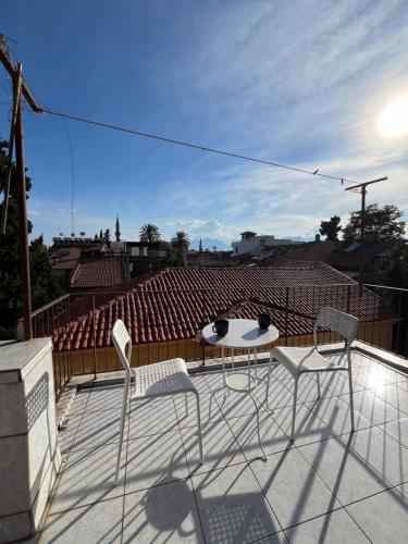eine Terrasse mit Stühlen und einem Tisch auf dem Dach in der Unterkunft Erkal Pension in Antalya