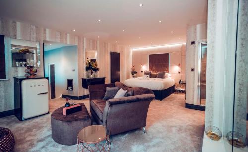 a living room with a bed and a couch and a room with a bed at Aphrodites Group - Luxury Hot Tub Suites in Central Lake District! in Bowness-on-Windermere