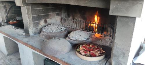 a brick oven with a pot of food in it at Villa Lavanda in Cres