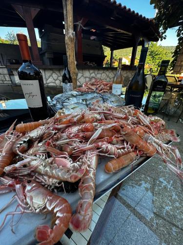 a bunch of lobsters on a table with bottles of wine at Villa Lavanda in Cres