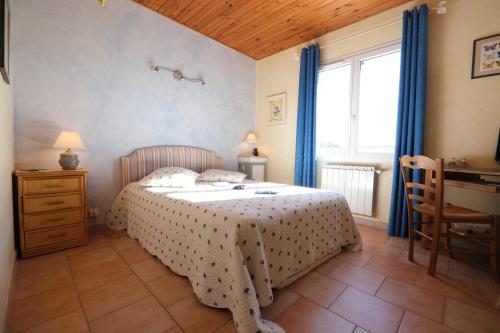 a bedroom with a bed and a desk and a window at pretty detached villa with private swimming pool, in Aureille, in the alpilles - 8 people in Aureille