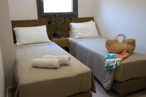 a room with two beds with towels on them at Tropical Beach A in Amoudara Herakliou