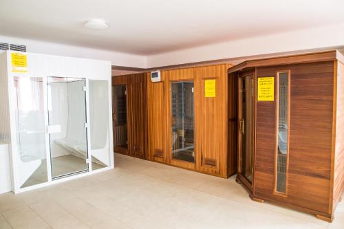 a row of doors in a room with yellow signs on them at Luxury Hotel Siófok in Siófok