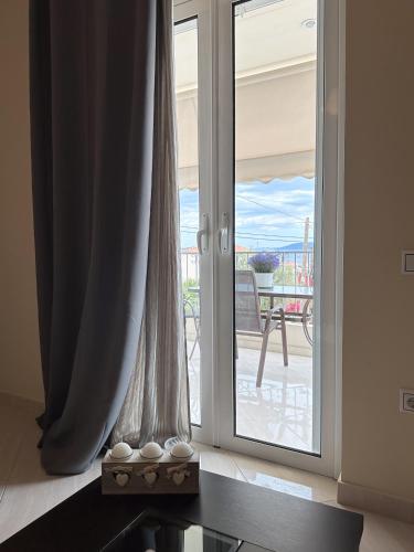 a sliding glass door with a view of a patio at Sun n' Salt I Apartment in Tolo