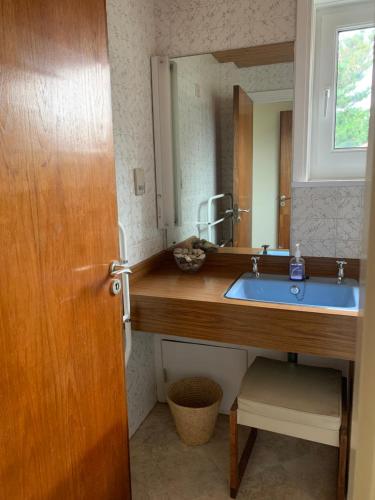 a bathroom with a sink and a mirror at South View - West Wittering beach house with direct beach access in West Wittering