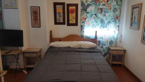 um quarto com uma cama e uma televisão em UMBRIA Mar em Punta Umbría