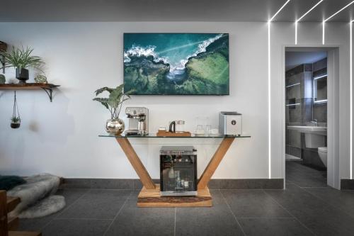 a room with a counter with a coffee machine on it at Aphrodites Group - Luxury Hot Tub Suites in Central Lake District! in Bowness-on-Windermere