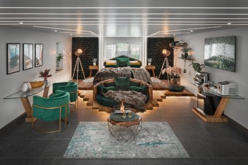 a bedroom with a bed and a living room at Aphrodites Group - Luxury Hot Tub Suites in Central Lake District! in Bowness-on-Windermere