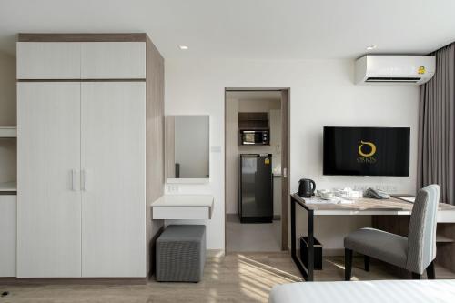a room with a desk and a computer in it at ORION Hotel & Residence Bangna in Bangkok