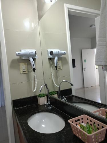 a bathroom with a sink and a mirror at Pousada Kalunga in Flecheiras